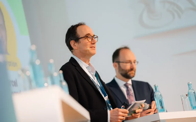 Moderation beim AOK Forum live Marcel Weigand, auf Bühne moderierend